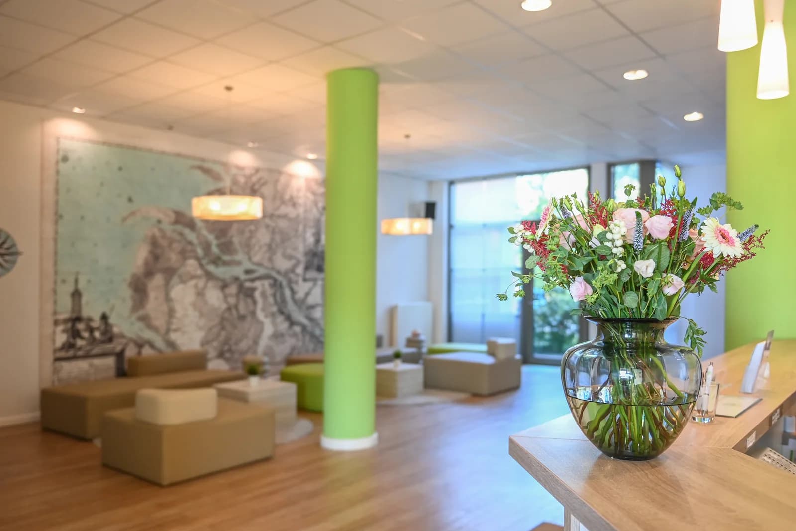 Lobby with seating area, green pillar and historical map